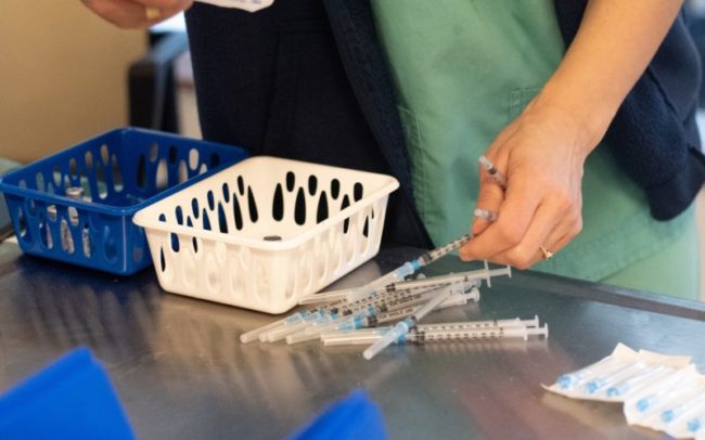 Hands,Of,Nurse,Prepares,To,Vaccinate,Older,People.,On,The